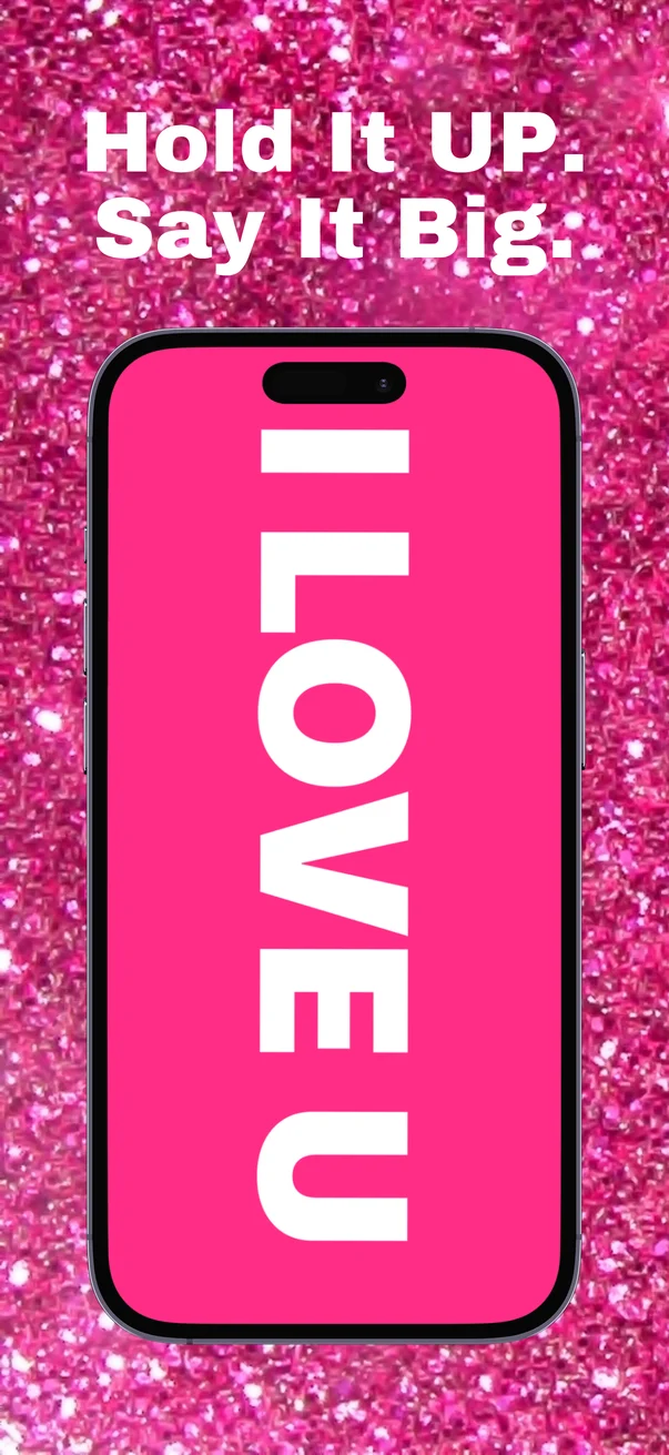 Hold it up, say it big: a full-screen pink sign reading I LOVE U